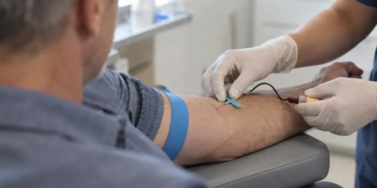 Man having blood drawn at a clinic for a testosterone blood test Man having blood drawn at a clinic for a testosterone blood test