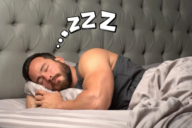 Muscular man sleeping soundly in bed, illustrating how good sleep supports testosterone production