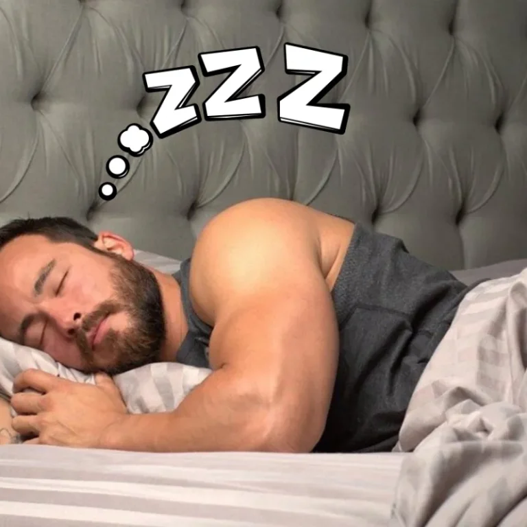 Muscular man sleeping soundly in bed, illustrating how good sleep supports testosterone production